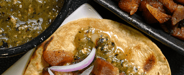 Pork cracklings in grilled salsa verde tacos